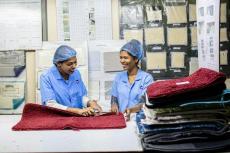 Engineers reviewing a product quality plan on a factory floor